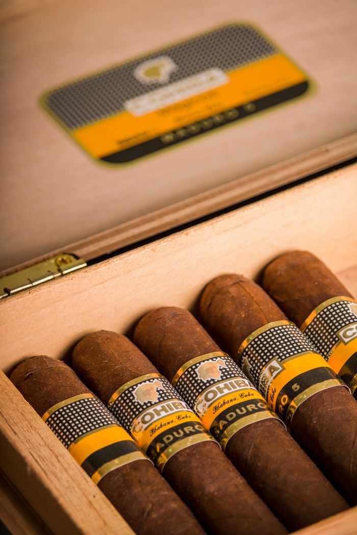 services-04 Close-up of Cohiba cigars in a wooden box, showcasing luxury and craftsmanship.