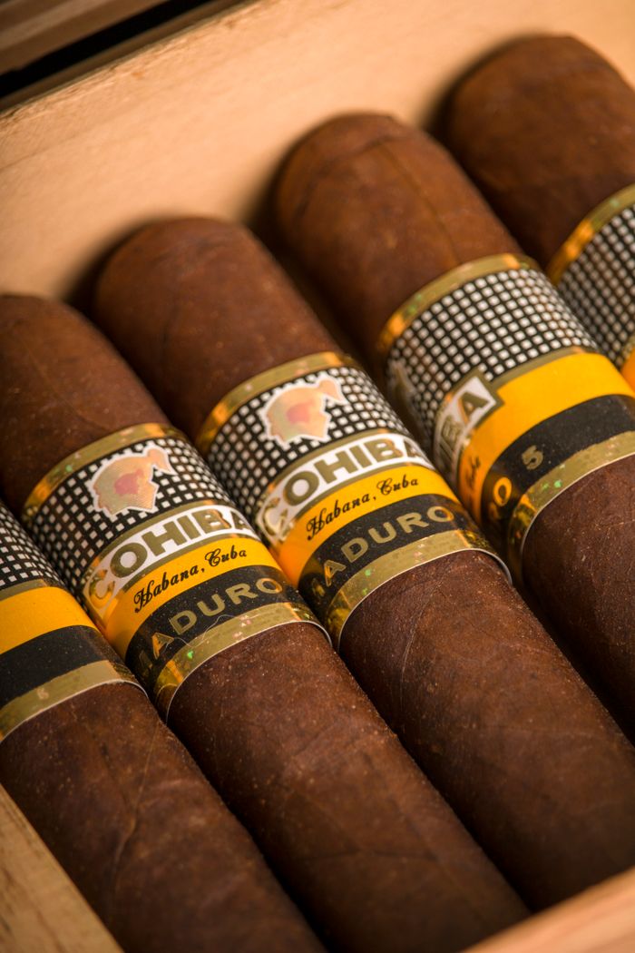 Smoke district las vegas A close-up shot of premium Cohiba cigars in a wooden box, showcasing their labels and rich texture.